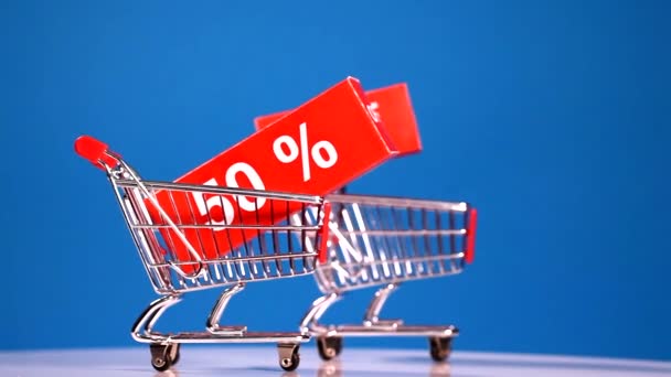 Moving shopping carts with sales icons — Stock Video