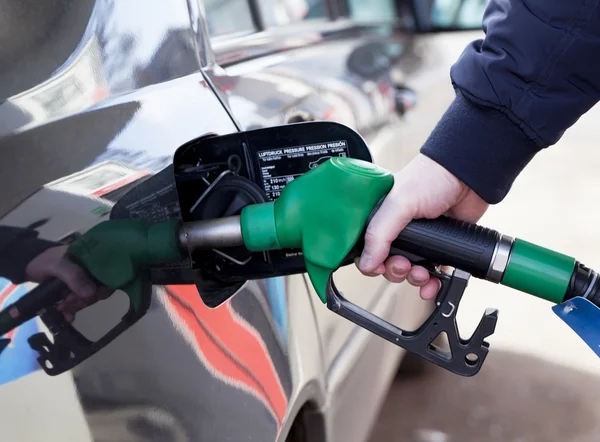 Man filling up car with fuel at petrol station Stock Picture