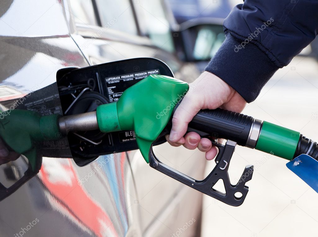 Man filling up car with fuel at petrol station