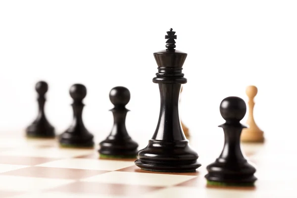 Black chess pieces on a chessboard standing in perspective — Stock Photo, Image