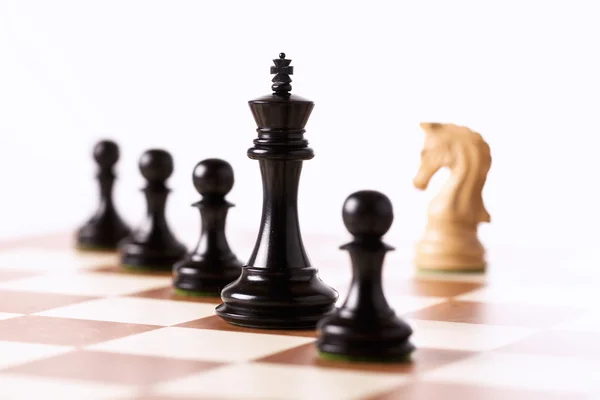 Black chess pieces on a chessboard standing in perspective — Stock Photo, Image