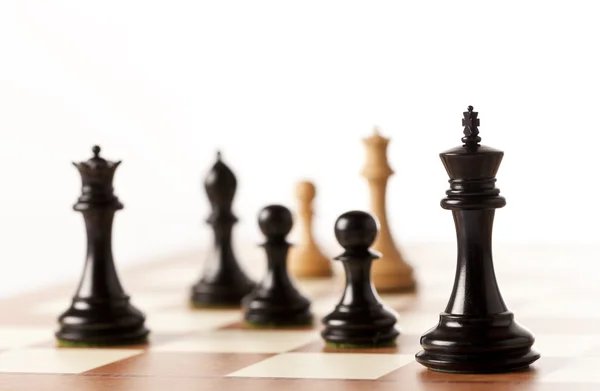 Black chess pieces on a chessboard standing in perspective — Stock Photo, Image