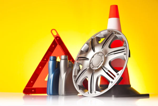 Road emergency items and car accessories on yellow background — Stock Photo, Image