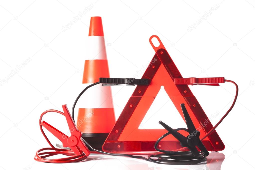 Warning triangle and jump start cable isolated on white