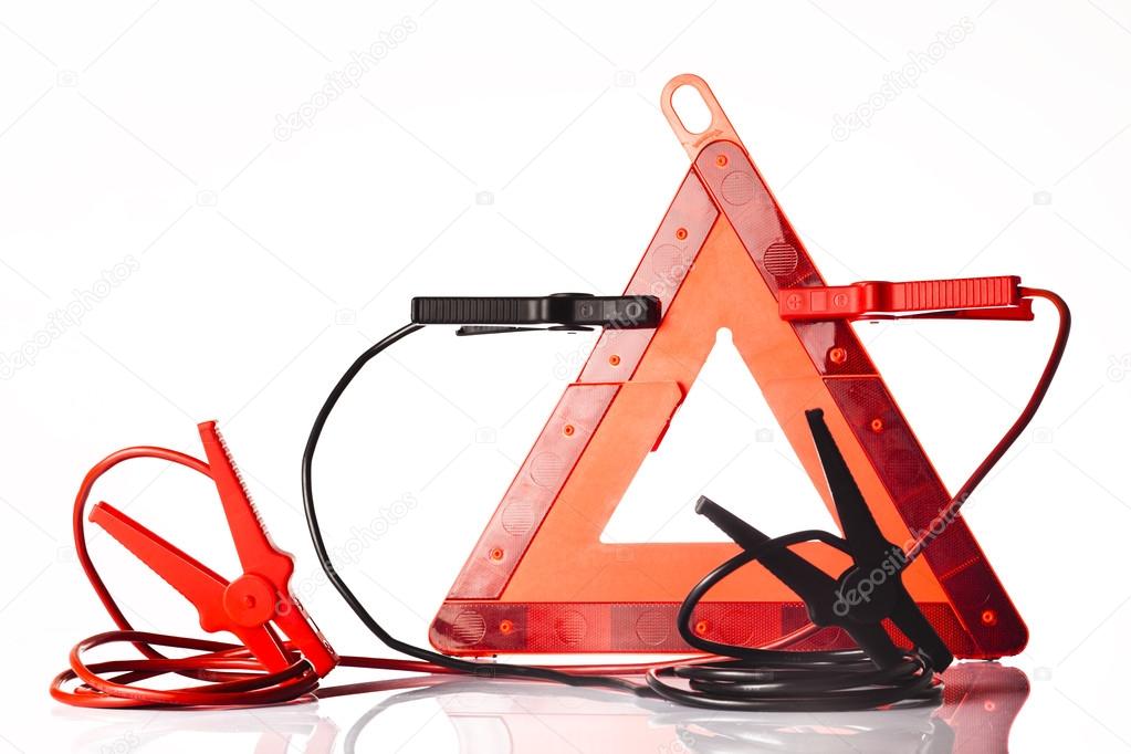 Warning triangle and jump start cable isolated on white