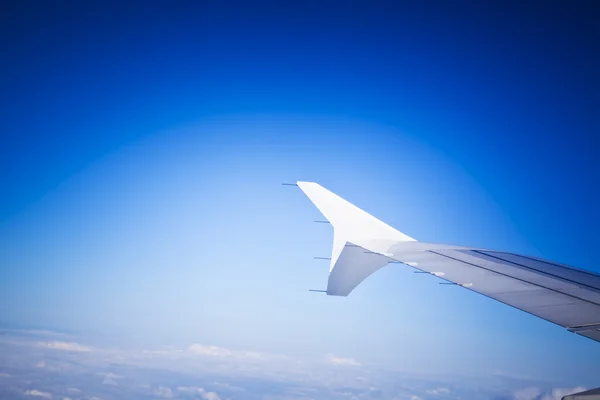 Wings of airplane een through window — Stock Photo, Image