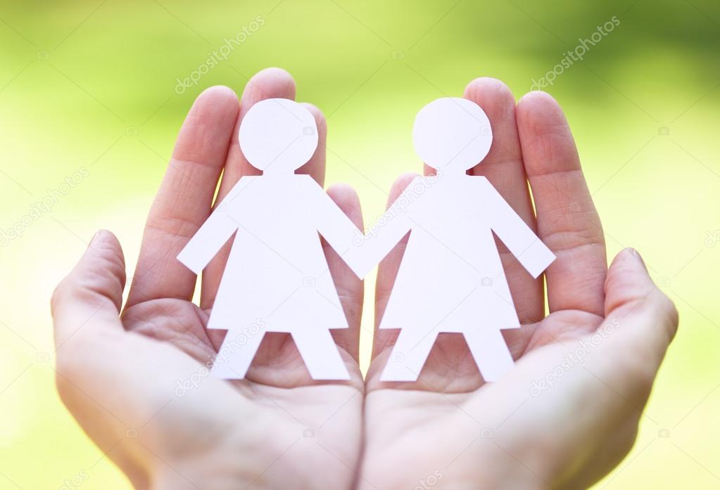 gay pride and love concept - close up of happy lesbian couple symbol in hands