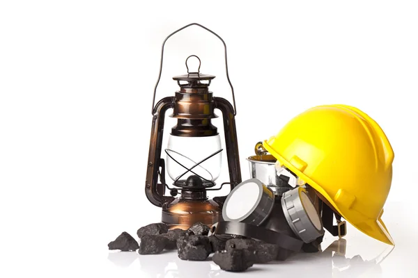 Mining tools with protective helmet, ear muffs and oil lantern — Stock Photo, Image