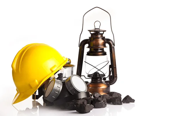 Mining tools with protective helmet, ear muffs and oil lantern — Stock Photo, Image