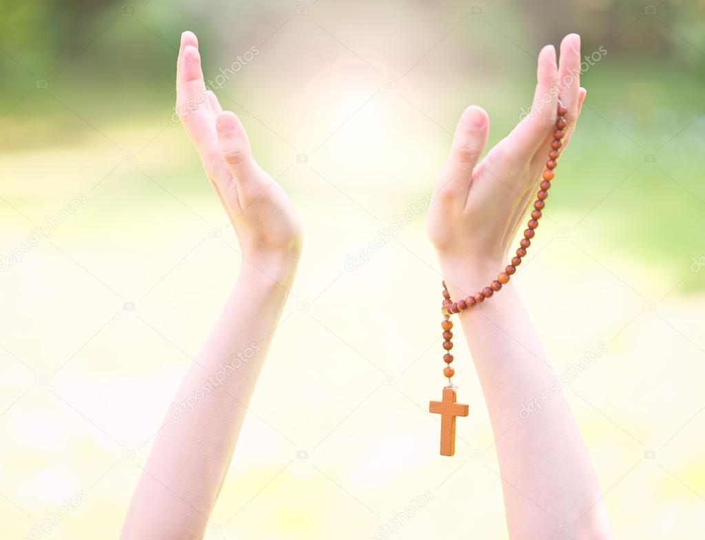 Rosary in hands, religious background