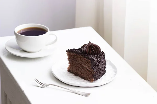 Schokoladenkuchen und Kaffee, Stillleben im hellen Interieur. — Stockfoto