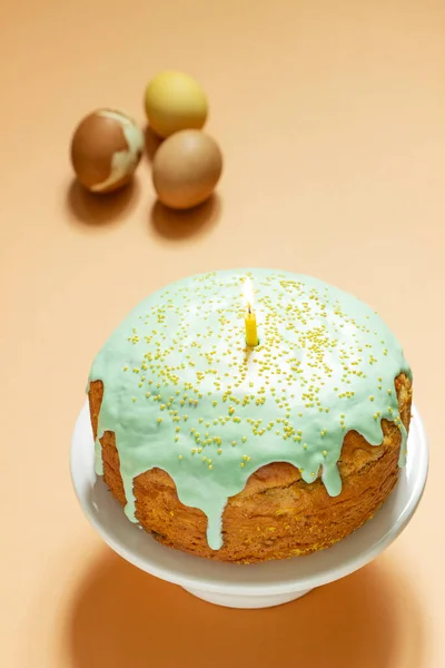 Easter cake covered with icing on a cake bowl and Easter eggs. Festive concept.