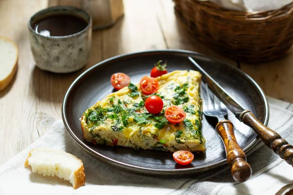 Breakfast of omelet with vegetables, herbs and cheese, served with bread and coffee. Royalty Free Stock Photos
