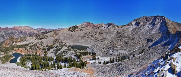 Red Pine Lake views from trail mountain landscape towards Salt Lake Valley in Little Cottonwood Canyon, Wasatch Rocky mountain Range, Utah, United States.