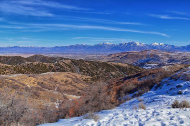 Winter Landscape panorama Oquirrh and Wasatch mountain views from Yellow Fork Canyon County Park Rose Canyon rim hiking trail by Rio Tinto Bingham Copper Mine, Utah. United States. clipart