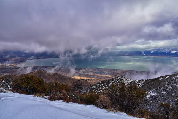 Lake Mountains Peak winter snow mountain hiking trail views via Israel Canyon towards Radio Towers, Utah Lake, Wasatch Front Rocky Mountains, Provo, Utah County. United States.