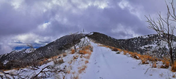 Lake Mountains Peak winter snow mountain hiking trail views via Israel Canyon towards Radio Towers, Utah Lake, Wasatch Front Rocky Mountains, Provo, Utah County. United States.