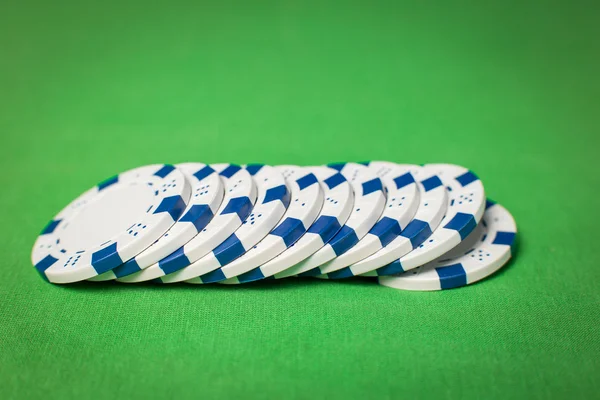 Stack of poker chips on a green table — Stock Photo, Image