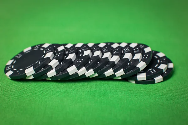 Stack of poker chips on a green table — Stock Photo, Image