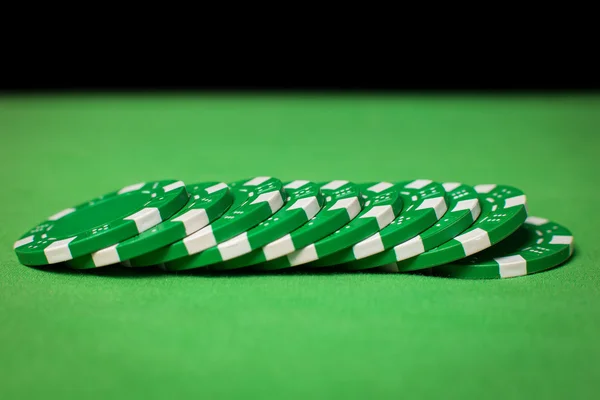 Stack of poker chips on a green table — Stock Photo, Image