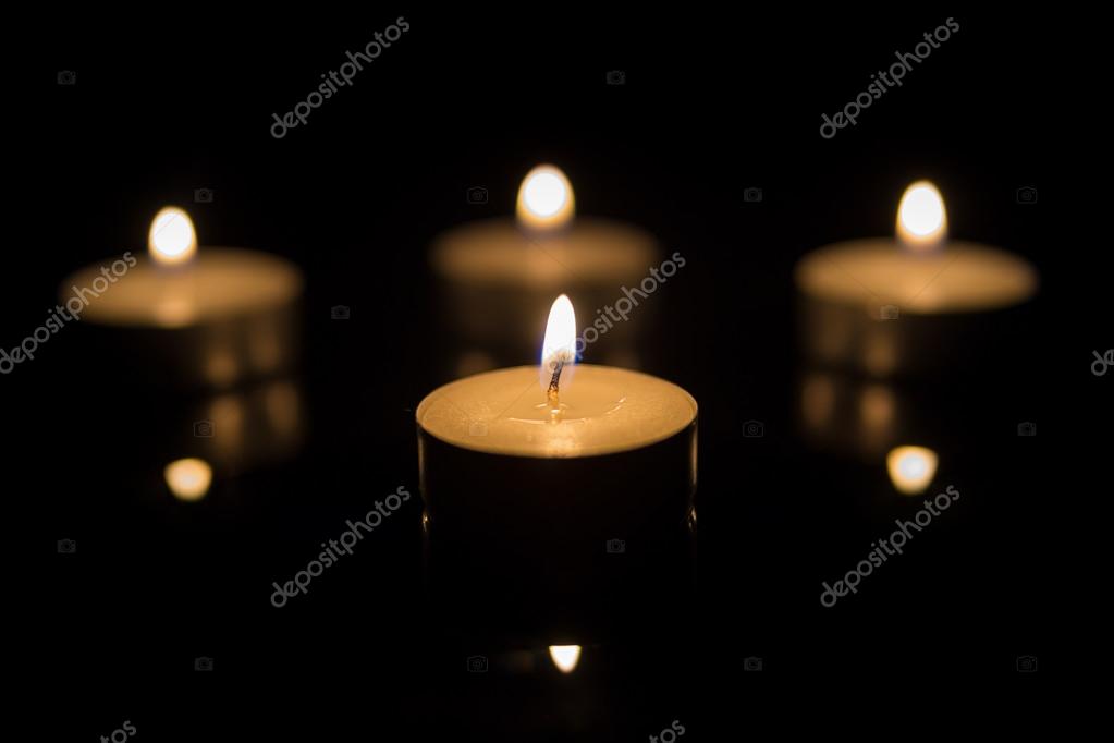 Four Tea Candles with Reflection on Black Stock Photo by ©bumi100