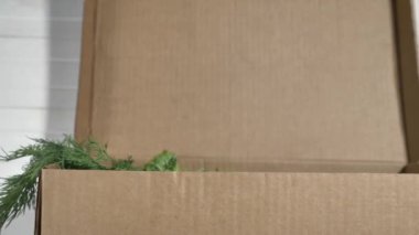 Kadınlar taze taze yeşillikleri karton kutuya atıyorlar.