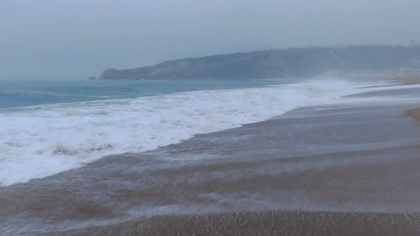 Дивовижні хвилі з білою піною рулон на чистому піску вид зверху — стокове відео