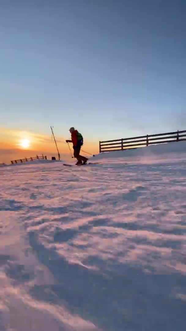 Спортсмен спускается по снежному склону горы утром — стоковое видео