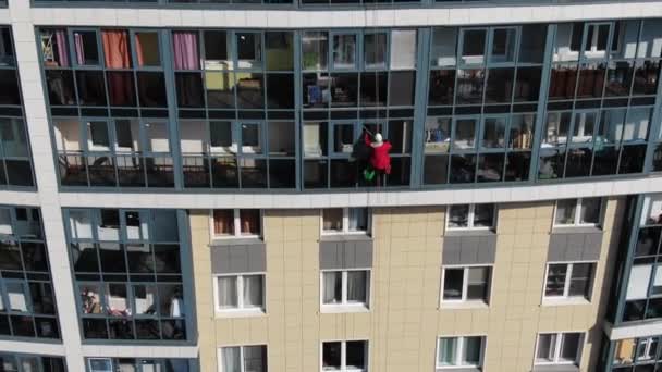 Ipari mászó tisztítja ablak a szálloda közelében folyó — Stock videók