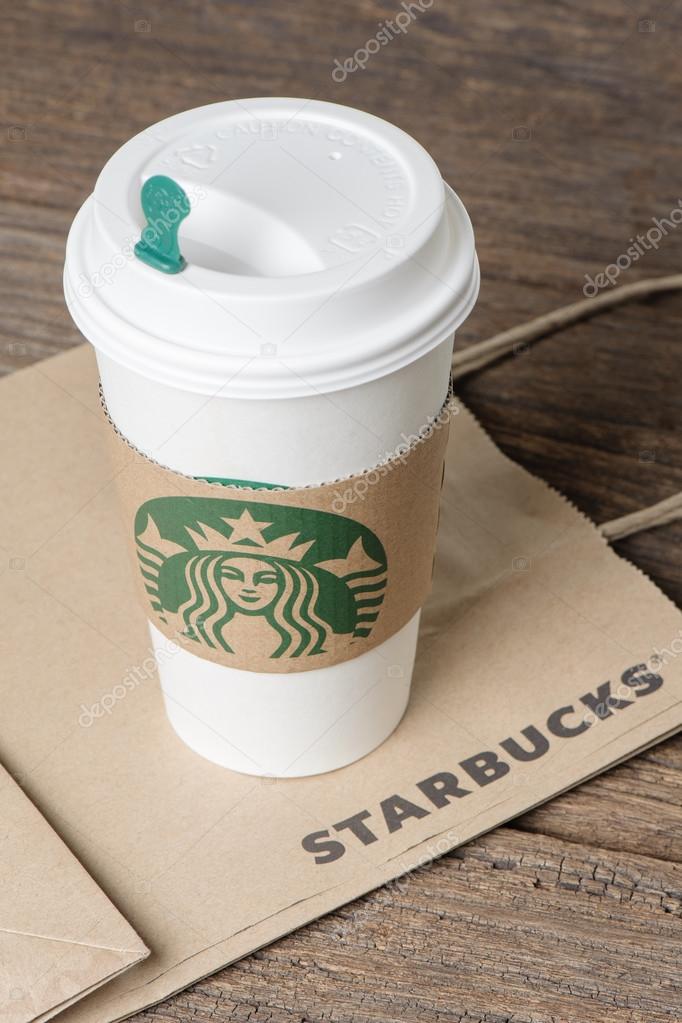 BANGKOK, THAILAND - FEBRUARY 26, 2015: White paper cup with sleeve with Starbucks logo. Starbucks is the world's largest coffee house with over 20,000 stores in 61 countries.