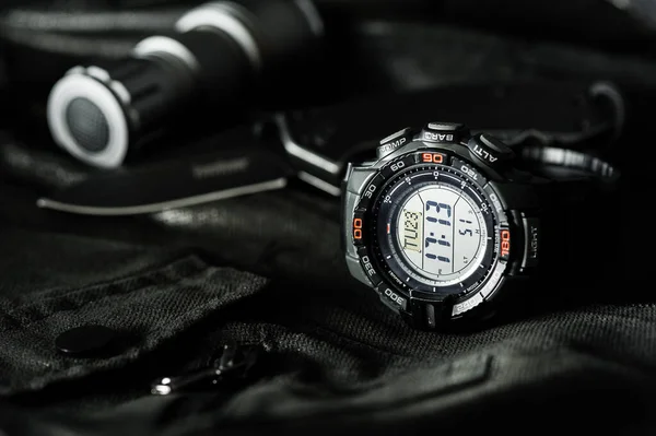Black digital watch for outdoor activities with stopwatch feature, countdown timer, backlight and water resistance.