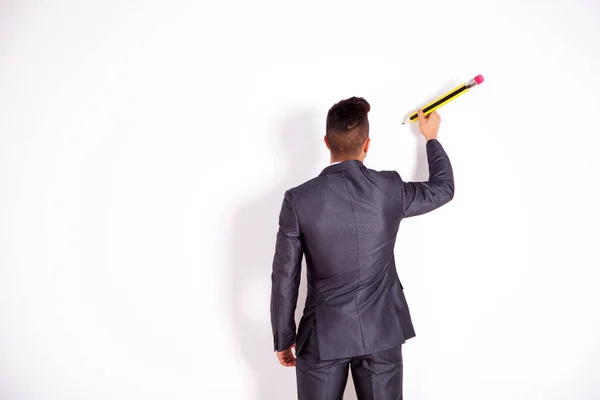 Businessman Writing Giant Pencil White Office Blank Wall — Stock Photo, Image