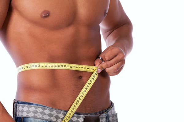 完璧な腹筋を持つ男彼の腰を測定 — ストック写真