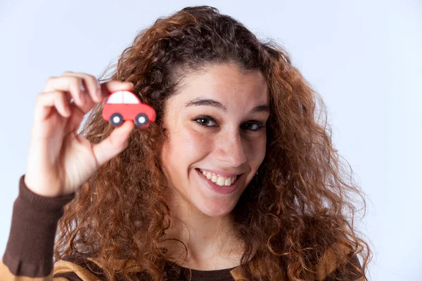 Happy Young Woman Showing Small Red Car — Stock Photo, Image