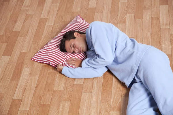 Hombre Joven Vestido Con Ropa Dormir Durmiendo Suelo Aislado Blanco —  Fotos de Stock