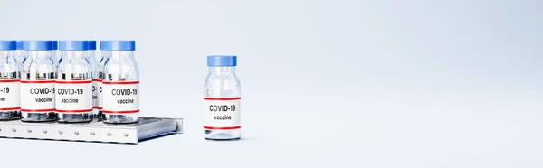Covid 19 Vaccine Bottles on Conveyor Belt on Blue with Copy Space — стокове фото