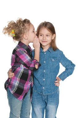 Little girl whispers something to her friend clipart