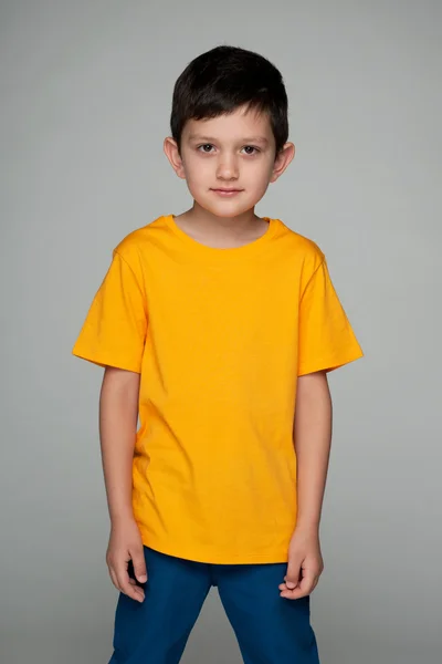 Fashion young boy in the yellow shirt — Stock Photo, Image