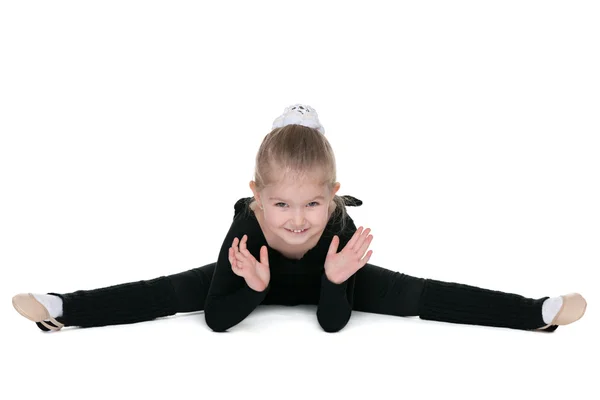 Little girl performs gymnastic exercise — Stock Photo, Image