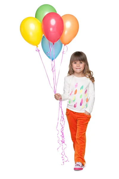 Leende liten flicka med ballonger — Stockfoto