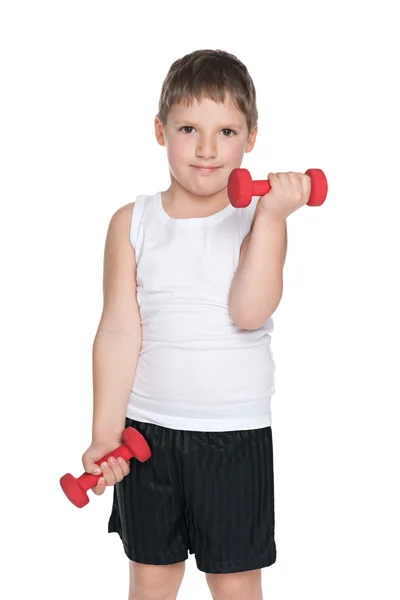 Confident young boy with dumbbells — Stock Photo, Image