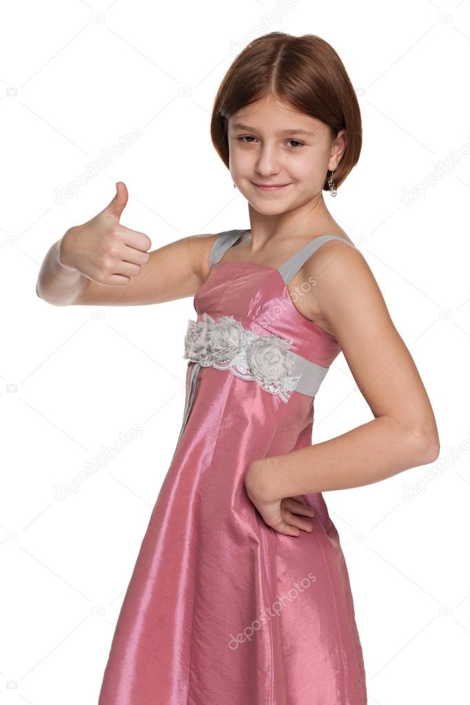 Pretty preteen girl holds her thumb up
