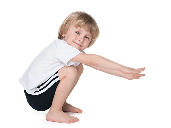 Preschool boy performs exercises — Stock Photo, Image