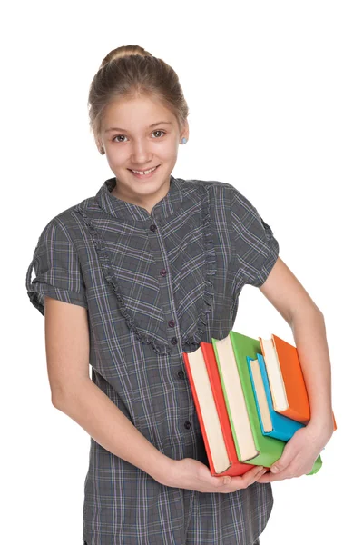 Gelukkig jong meisje houdt boeken — Stockfoto