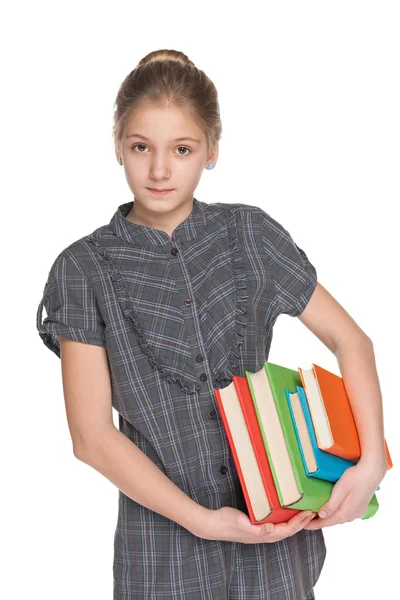 Chica joven inteligente sostiene libros — Foto de Stock