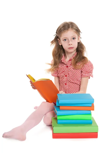 Serious young girl reads book Stock Photo
