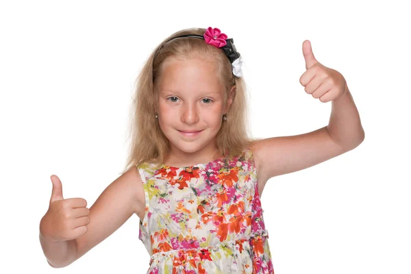 Cute little girl holds her thumbs up — Stock Photo, Image