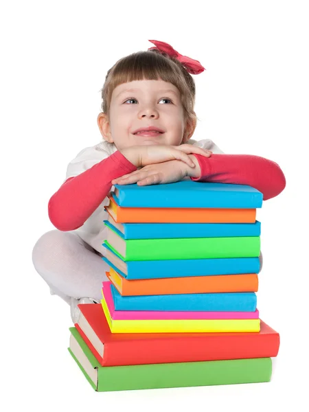 Pensive little girl near books — Stock Photo, Image