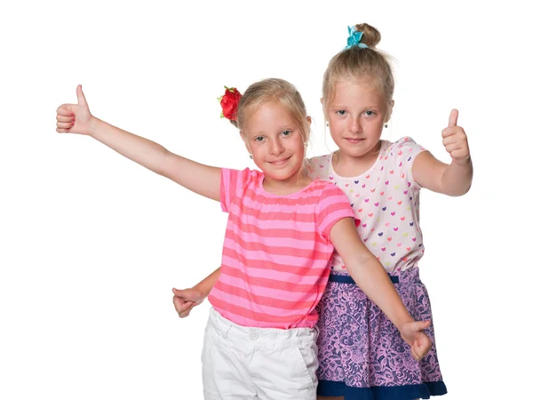 Meninas alegres segurar seus polegares para cima — Fotografia de Stock