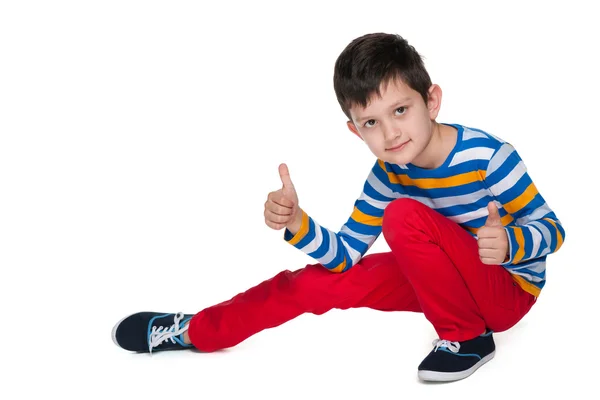 Fashion young boy holds his thumbs up — Stock Photo, Image